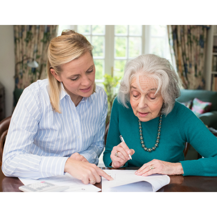 Carer supporting an older person in a warm home setting